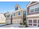 A row of stylish townhomes with a mix of brick and siding facades, each with a two-car garage at 38 Trailview Ln, Hiram, GA 30141