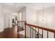 Upstairs hallway with hardwood floors, natural lighting and decorative light fixture at 38 Trailview Ln, Hiram, GA 30141