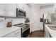 Modern kitchen design with stainless steel appliances, white cabinetry and quartz countertops at 38 Trailview Ln, Hiram, GA 30141