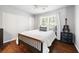 Neutral bedroom showcasing wood floors, a dark dresser, and a bright window at 384 Wesley Dr, Acworth, GA 30101