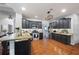 Open kitchen with stainless steel appliances, dark cabinetry, granite countertops, and hardwood floors at 384 Wesley Dr, Acworth, GA 30101