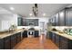 Modern kitchen boasts stainless appliances, granite counters, and dark cabinets with under-cabinet lighting at 384 Wesley Dr, Acworth, GA 30101