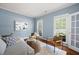 Comfortable living area with soft blue walls, hardwood floors and an abundance of natural light at 384 Wesley Dr, Acworth, GA 30101