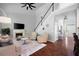 Welcoming living room with fireplace, staircase, and ample natural light from large windows at 384 Wesley Dr, Acworth, GA 30101