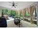 View of a covered patio with outdoor dining, fan, curtains and a landscaped yard at 384 Wesley Dr, Acworth, GA 30101