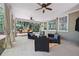 Relaxing covered patio with outdoor seating, ceiling fans and curtains overlooking a beautiful backyard at 384 Wesley Dr, Acworth, GA 30101