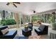 Relaxing covered patio with outdoor seating, ceiling fans and curtains overlooking a beautiful backyard at 384 Wesley Dr, Acworth, GA 30101