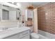 Bathroom features a combination tub and shower plus functional storage at 5566 River Heights Se Xing, Marietta, GA 30067