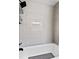 Bathroom showcasing a tub and tile surround and matte black showerhead at 5566 River Heights Se Xing, Marietta, GA 30067