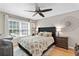 Comfortable bedroom with a large window, neutral décor, and a ceiling fan at 5566 River Heights Se Xing, Marietta, GA 30067