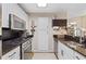 Modern kitchen featuring granite countertops, stainless steel appliances, and ample cabinet space at 5566 River Heights Se Xing, Marietta, GA 30067