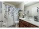 Bright bathroom with modern vanity, large mirror, and decorative shower curtain at 6150 Thorncrest Dr, Tucker, GA 30084