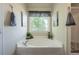 Soaking tub, perfect for relaxation, featuring stylish decor and natural light at 6150 Thorncrest Dr, Tucker, GA 30084