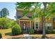 Charming two-story brick home with manicured lawn and covered front porch at 6150 Thorncrest Dr, Tucker, GA 30084