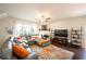 Cozy living room featuring a plush sectional sofa, fireplace, and large windows at 6150 Thorncrest Dr, Tucker, GA 30084