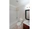 Clean bathroom with shower-tub combo, white fixtures, and vanity with a dark wood cabinet at 841 Sapphire Ln, Sugar Hill, GA 30518