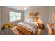Cozy bedroom with ample sunlight, wooden furniture, decorative accents, and carpet flooring for comfort at 841 Sapphire Ln, Sugar Hill, GA 30518