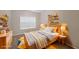 Bright bedroom with a large window, decorative shelves, comfortable furniture, and carpet for warmth at 841 Sapphire Ln, Sugar Hill, GA 30518