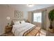 Serene bedroom with neutral tones, large window, comfortable bed, and stylish accents for relaxation at 841 Sapphire Ln, Sugar Hill, GA 30518