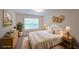 Comfortable bedroom with a large window, neutral tones, and stylish decor creating a relaxing atmosphere at 841 Sapphire Ln, Sugar Hill, GA 30518