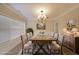 Formal dining room with chandelier, neutral colors, and a large window for natural light at 841 Sapphire Ln, Sugar Hill, GA 30518