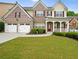 Charming two-story brick home with well-manicured lawn, a two-car garage and inviting front porch at 841 Sapphire Ln, Sugar Hill, GA 30518