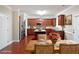 Open-concept kitchen with stainless steel appliances seamlessly connected to a dining area, and virtually staged decor at 841 Sapphire Ln, Sugar Hill, GA 30518