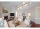 Bright living room with fireplace, soaring ceilings, and ample natural light, virtually staged with modern decor at 841 Sapphire Ln, Sugar Hill, GA 30518