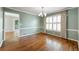Well-lit dining room with hardwood floors, chair rail, and plantation shutters at 1214 Defoors Nw Ct # 1A, Atlanta, GA 30318