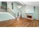 Spacious living room with hardwood floors, fireplace, and vaulted ceilings with attractive light fixture at 1214 Defoors Nw Ct # 1A, Atlanta, GA 30318