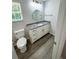 Updated bathroom with granite vanity, gold fixtures, and wood-look flooring at 1331 E Atlanta E Rd, Stockbridge, GA 30281