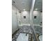 Elegant bathroom featuring white tile, granite countertops, gold fixtures, and modern lighting at 1331 E Atlanta E Rd, Stockbridge, GA 30281