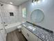 Stylish bathroom featuring white tile, granite countertop, gold fixtures, and modern lighting at 1331 E Atlanta E Rd, Stockbridge, GA 30281