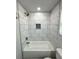 A crisp, white bathroom features marble-style tiling and gold fixtures at 1331 E Atlanta E Rd, Stockbridge, GA 30281