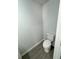 Powder room featuring modern toilet, base trim, and gray luxury vinyl plank flooring at 1331 E Atlanta E Rd, Stockbridge, GA 30281