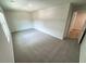 A well-lit bedroom features neutral walls, carpet flooring, and a view from the bright window at 1331 E Atlanta E Rd, Stockbridge, GA 30281
