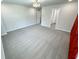 Spacious bedroom with gray carpet, red accent wall, and modern light fixture at 1331 E Atlanta E Rd, Stockbridge, GA 30281