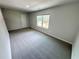 Bright, carpeted bedroom featuring neutral paint, natural light, and a door leading to other spaces at 1331 E Atlanta E Rd, Stockbridge, GA 30281