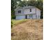 A lovely two-story house with a garage, light siding, new roof, and a neat front yard at 1331 E Atlanta E Rd, Stockbridge, GA 30281