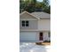 Charming two-story home featuring light siding, a dark roof, and a spacious two-car garage at 1331 E Atlanta E Rd, Stockbridge, GA 30281