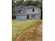 Charming two-story home featuring an attached garage, a red door, and a freshly cut front lawn at 1331 E Atlanta E Rd, Stockbridge, GA 30281