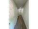 Hallway with multiple white paneled doors and wood grain vinyl flooring at 1331 E Atlanta E Rd, Stockbridge, GA 30281