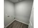 Laundry room with washer hookups, white walls and wood grain vinyl flooring at 1331 E Atlanta E Rd, Stockbridge, GA 30281