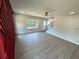 Bright living room with hardwood floors, large window, and a unique red accent wall near the entry at 1331 E Atlanta E Rd, Stockbridge, GA 30281