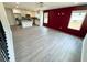Open-concept living room and kitchen with modern finishes, grey flooring, and a decorative accent wall at 1331 E Atlanta E Rd, Stockbridge, GA 30281