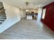 Open-concept living space features hardwood floors, bright windows, and a decorative red accent wall at 1331 E Atlanta E Rd, Stockbridge, GA 30281