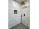 Modern shower featuring white tile, gold fixtures, and a rain shower head at 1331 E Atlanta E Rd, Stockbridge, GA 30281