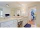 Bright bathroom with double sink vanity, large mirror, and walk-in closet access at 2567 Hyde Manor Nw Dr, Atlanta, GA 30327