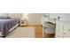 Bright bedroom featuring hardwood floors, elegant furniture, and a decorative rug at 2567 Hyde Manor Nw Dr, Atlanta, GA 30327