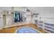 Spacious walk-in closet with custom shelving and hardwood floors at 2567 Hyde Manor Nw Dr, Atlanta, GA 30327